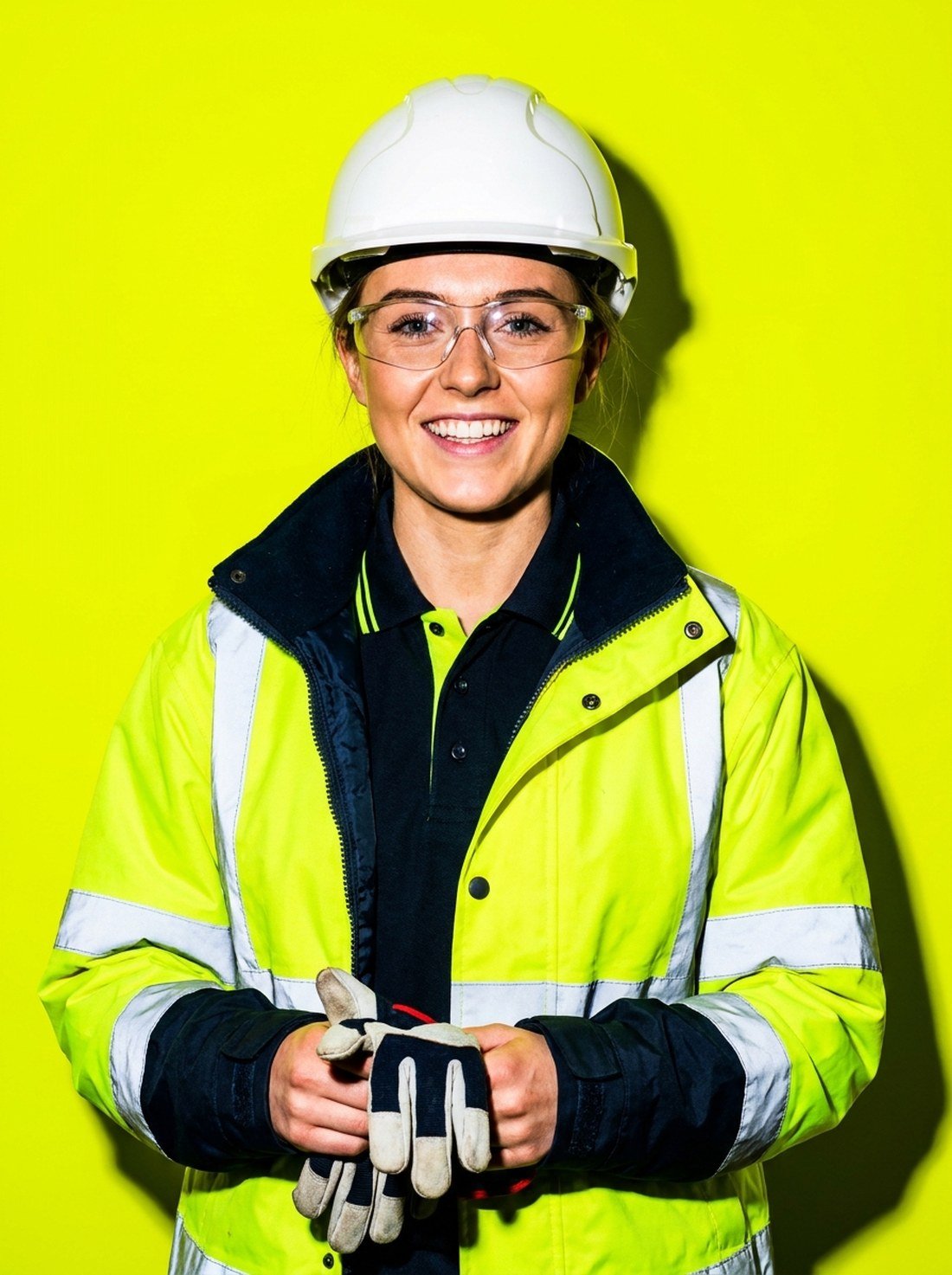 Worker in hi-vis jacket on chartreuse background